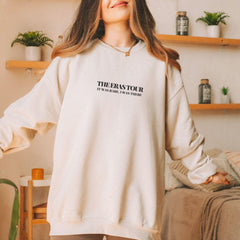 a woman standing in a room with a white sweatshirt on