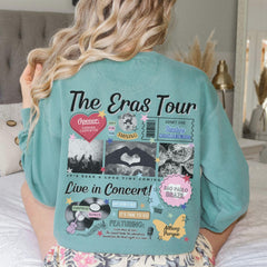 a woman sitting on top of a bed wearing a green shirt