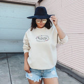 a woman wearing a hat and a sweatshirt