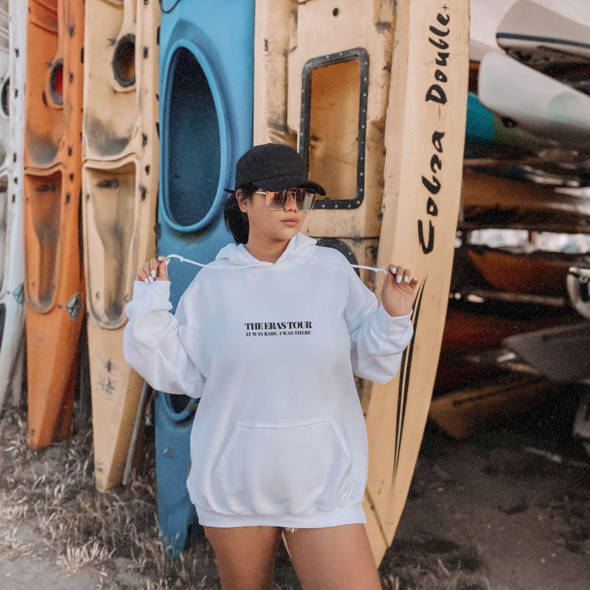 a woman standing in front of a row of surfboards