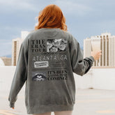a woman with red hair is holding a book