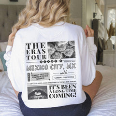 a woman sitting on a bed with her back to the camera