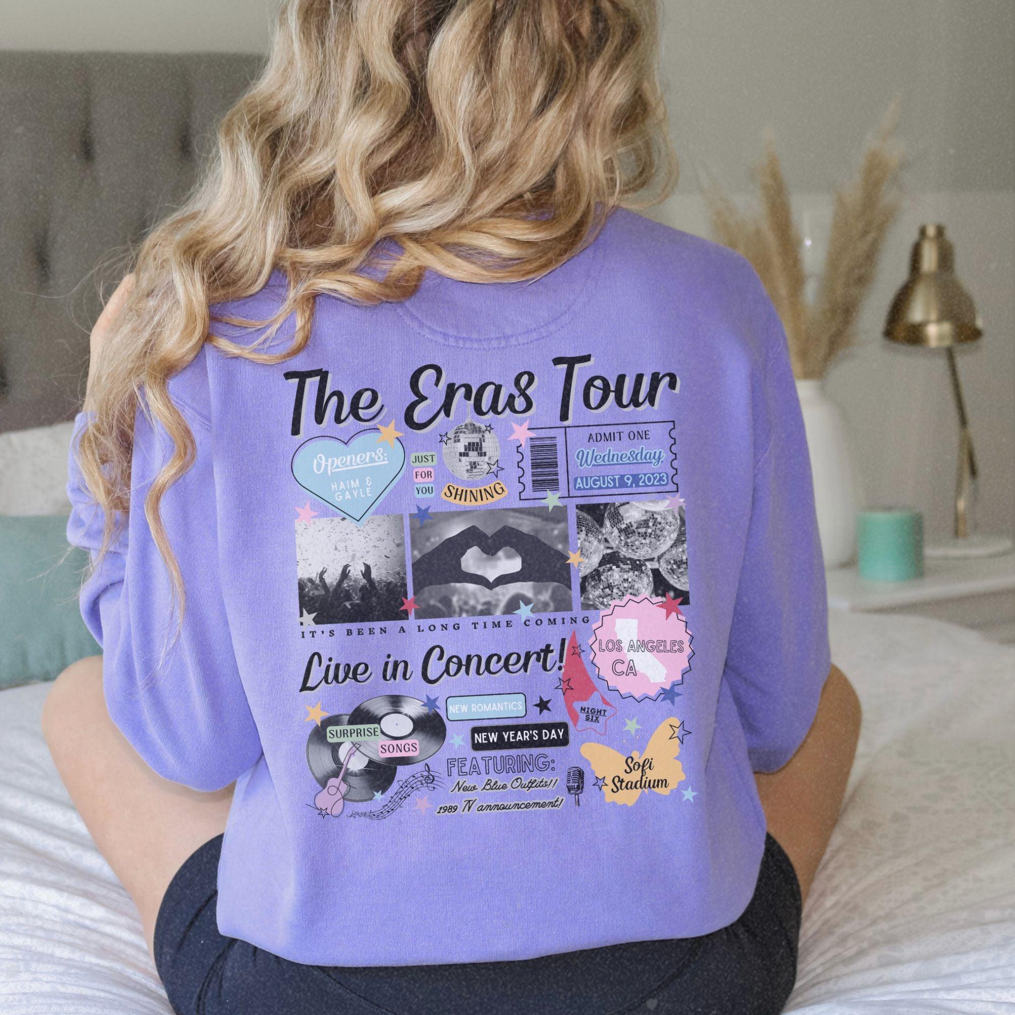 a woman sitting on a bed wearing a purple shirt