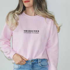 a woman wearing a pink sweatshirt and jeans