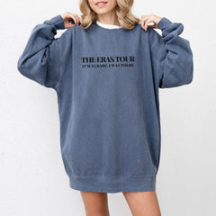 a woman wearing a sweatshirt dress with the words the erase tour printed on it