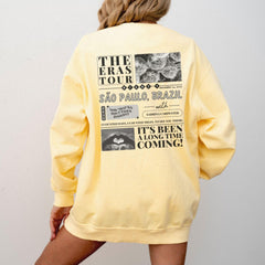 a woman wearing a yellow sweatshirt and shorts