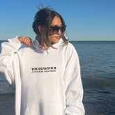 a woman standing on a beach next to the ocean