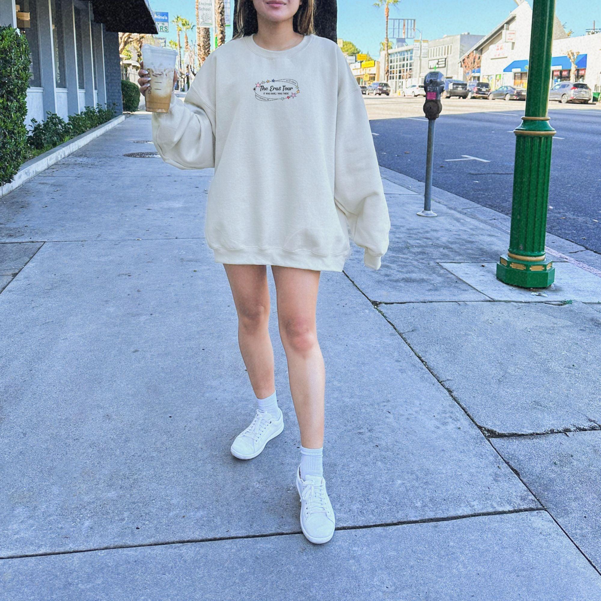a woman walking down a sidewalk holding an umbrella