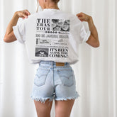 a woman wearing a white shirt and jean shorts