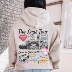 a woman wearing a white hoodie with the words the eras tour printed on it