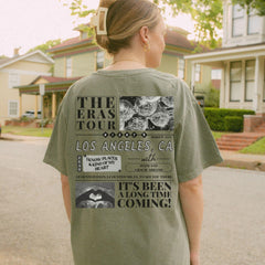 a woman standing on a street with a skateboard