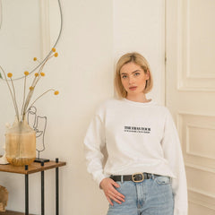 a woman standing in front of a mirror