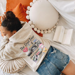a woman laying on top of a bed covered in a blanket