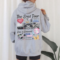 a woman wearing a gray hoodie with the words the eras tour printed on it