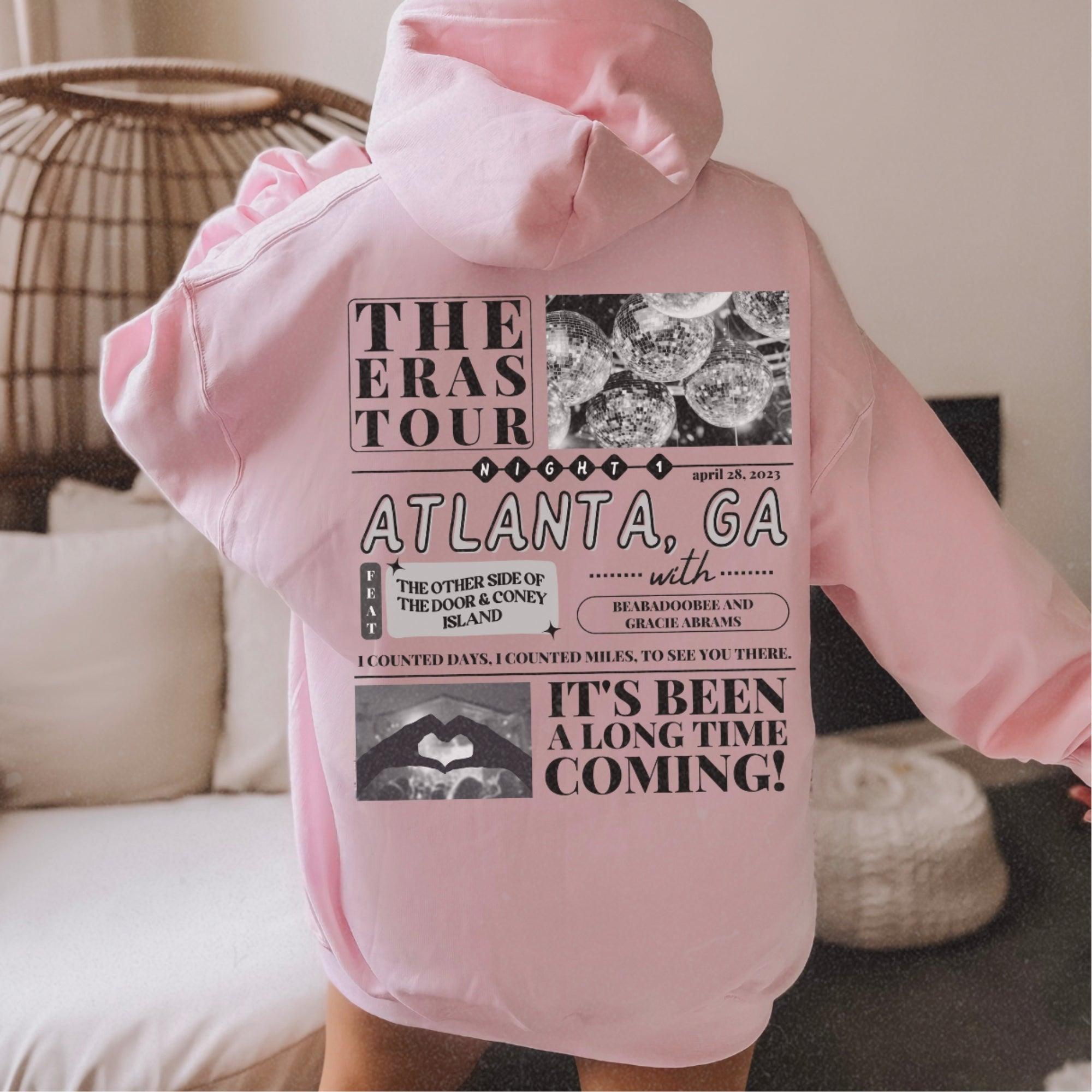a person wearing a pink hoodie with pictures on it