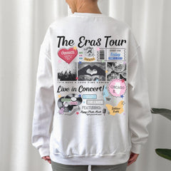 a woman wearing a white sweatshirt with the words the eras tour on it