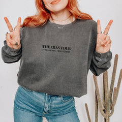 a woman with red hair wearing a grey sweatshirt