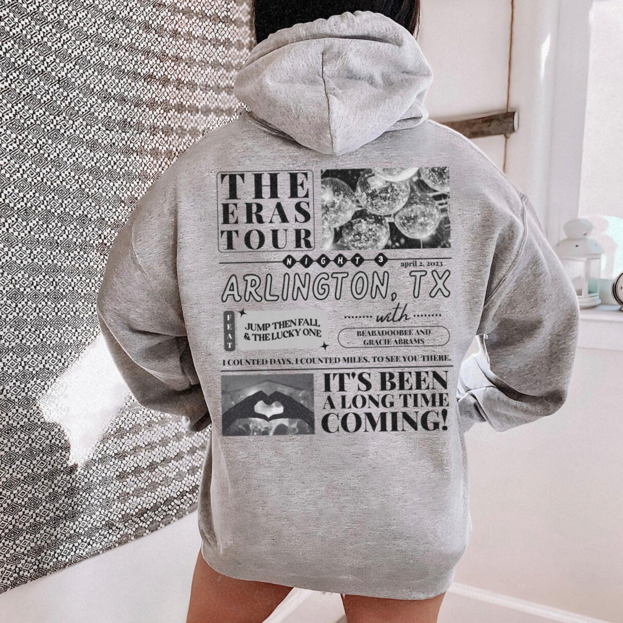 a person standing in a bathroom wearing a gray hoodie