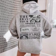 a person standing in a bathroom wearing a gray hoodie
