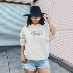 a woman wearing a hat and a sweatshirt