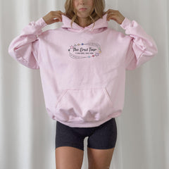 a woman wearing a pink hoodie and black shorts