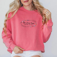 a woman wearing a pink sweatshirt and white shorts