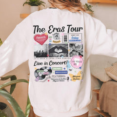a woman wearing a white sweatshirt with the words the eras tour printed on it
