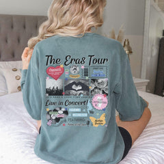 a woman sitting on top of a bed wearing a blue shirt