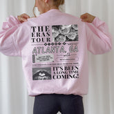 a woman wearing a pink jacket with pictures on it