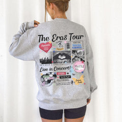 a woman wearing a grey sweatshirt with the words the eras tour on it