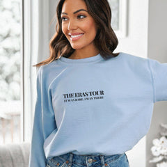 a woman wearing a blue sweatshirt and jeans