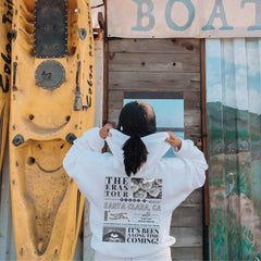 a woman standing in front of a yellow boat