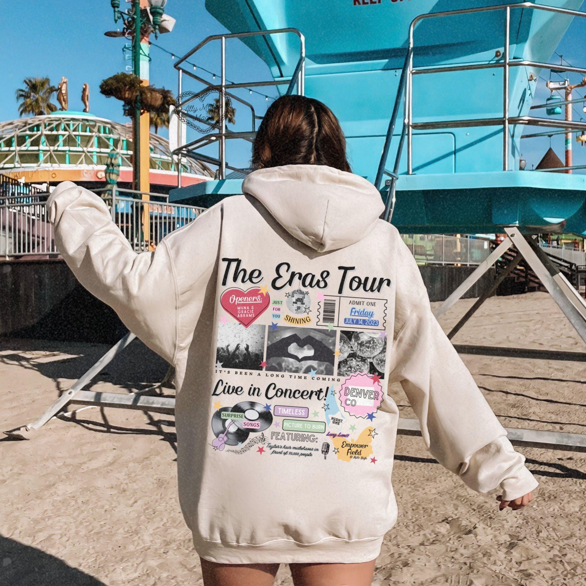 a woman in a white hoodie walking towards a blue lifeguard tower