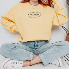 a woman sitting on the floor with her hands on her hips