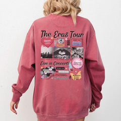 a woman wearing a pink sweatshirt with the words the eras tour on it