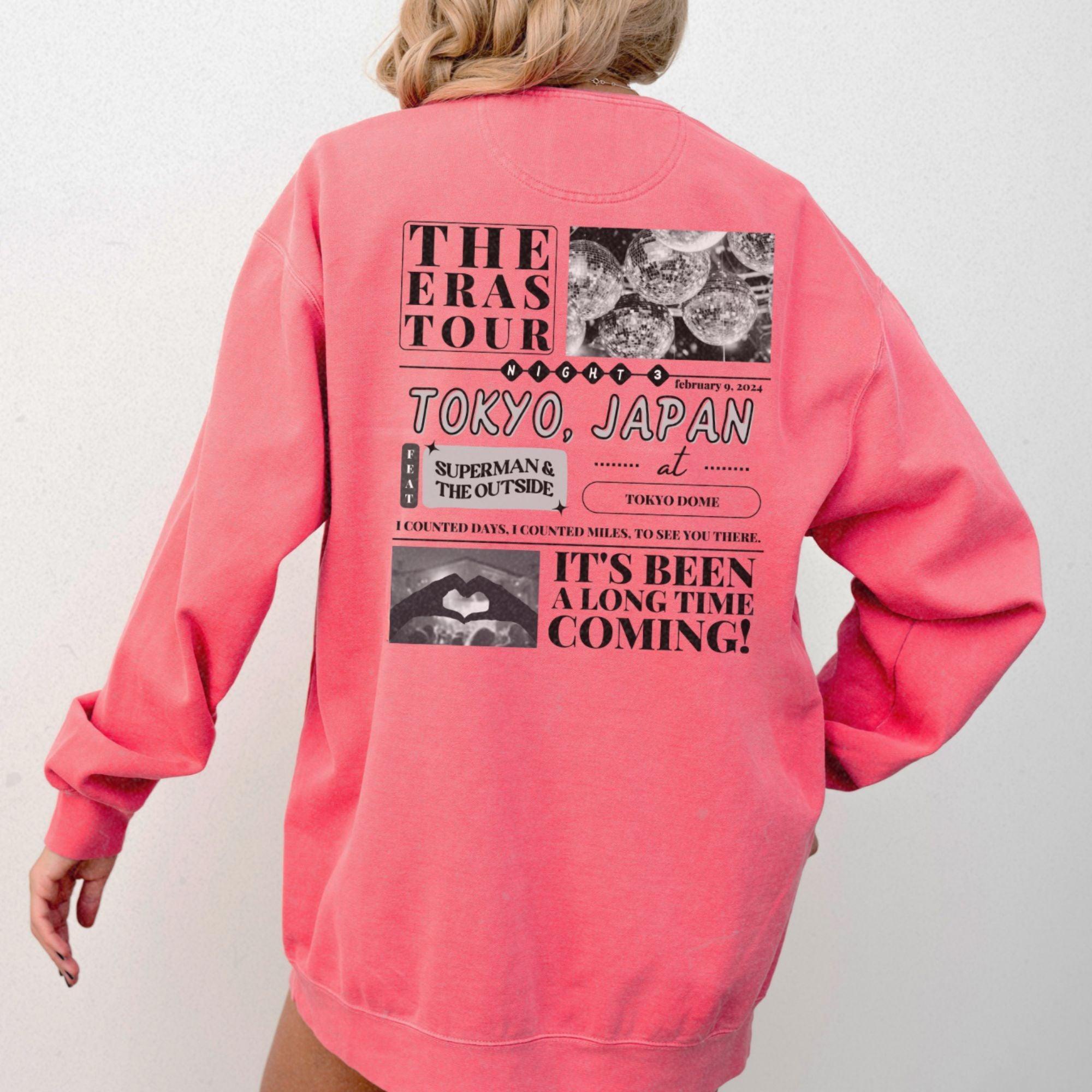 a woman wearing a pink sweatshirt jacket with a picture of a woman's face