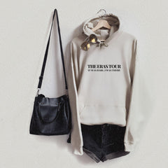 a white sweatshirt and black shorts hanging on a wall