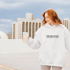 a woman in a white sweatshirt holding a glass of milk