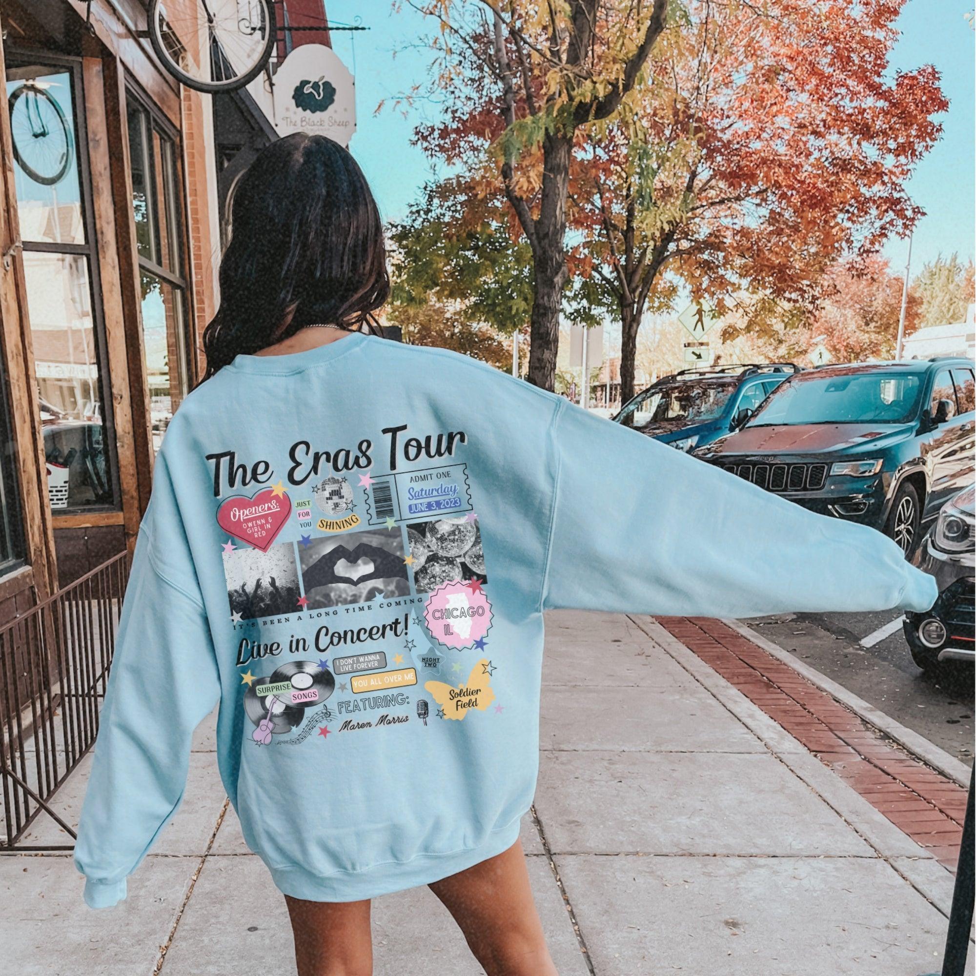 a woman in a blue sweatshirt is walking down the street
