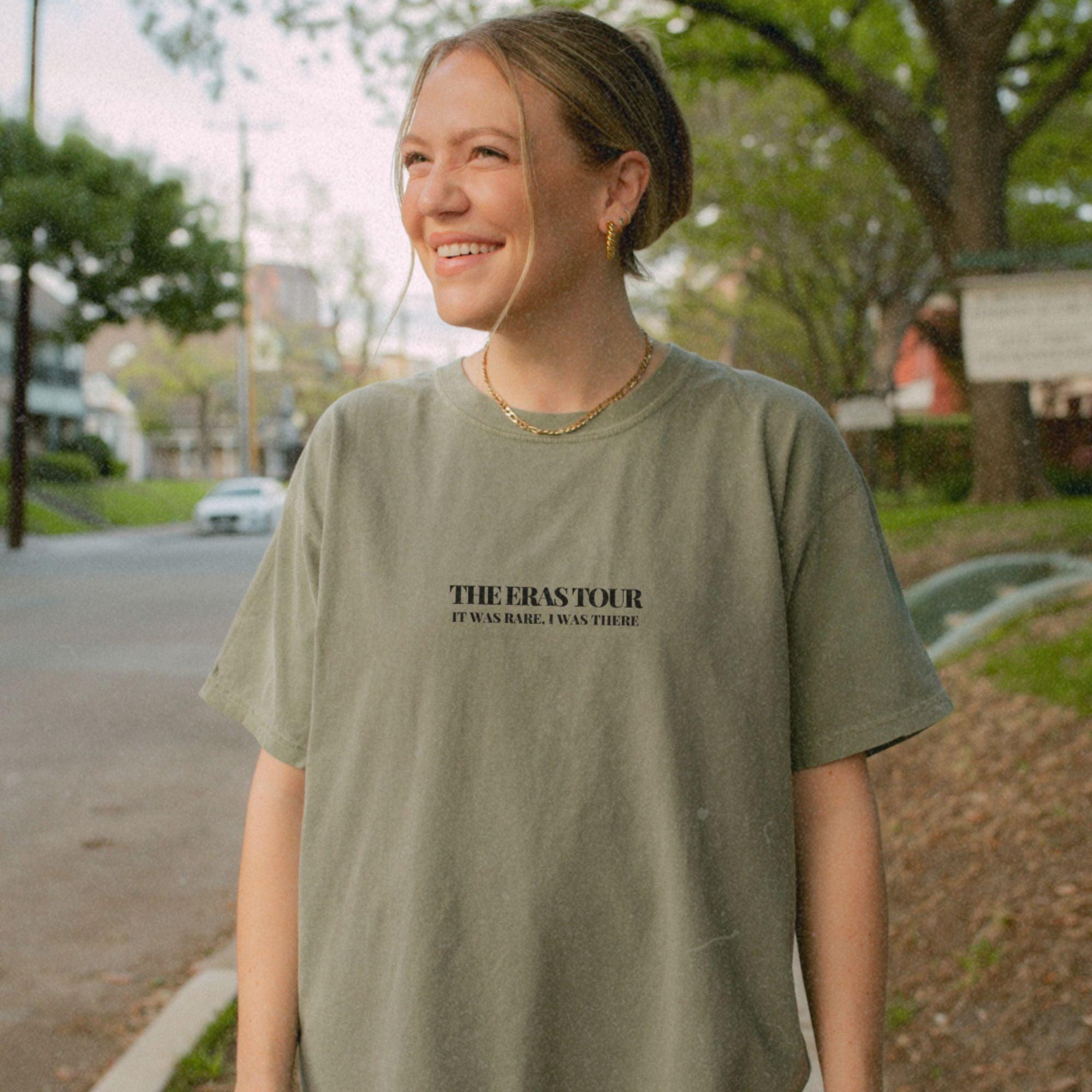 a woman standing on the side of a road