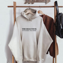 a white sweatshirt hanging on a coat rack