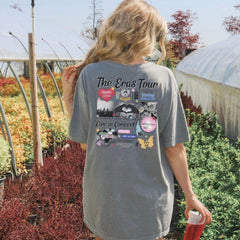 a woman walking in a garden holding a red umbrella