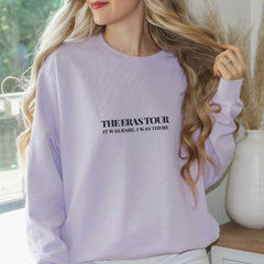 a woman with long blonde hair wearing a purple sweatshirt