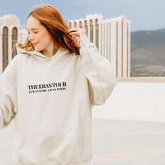 a woman with red hair wearing a white sweatshirt