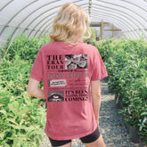 a woman standing in a greenhouse looking at plants