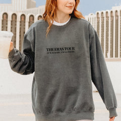 a woman in a sweatshirt holding a drink