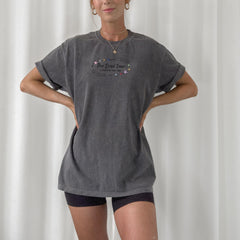 a woman standing in front of a white curtain