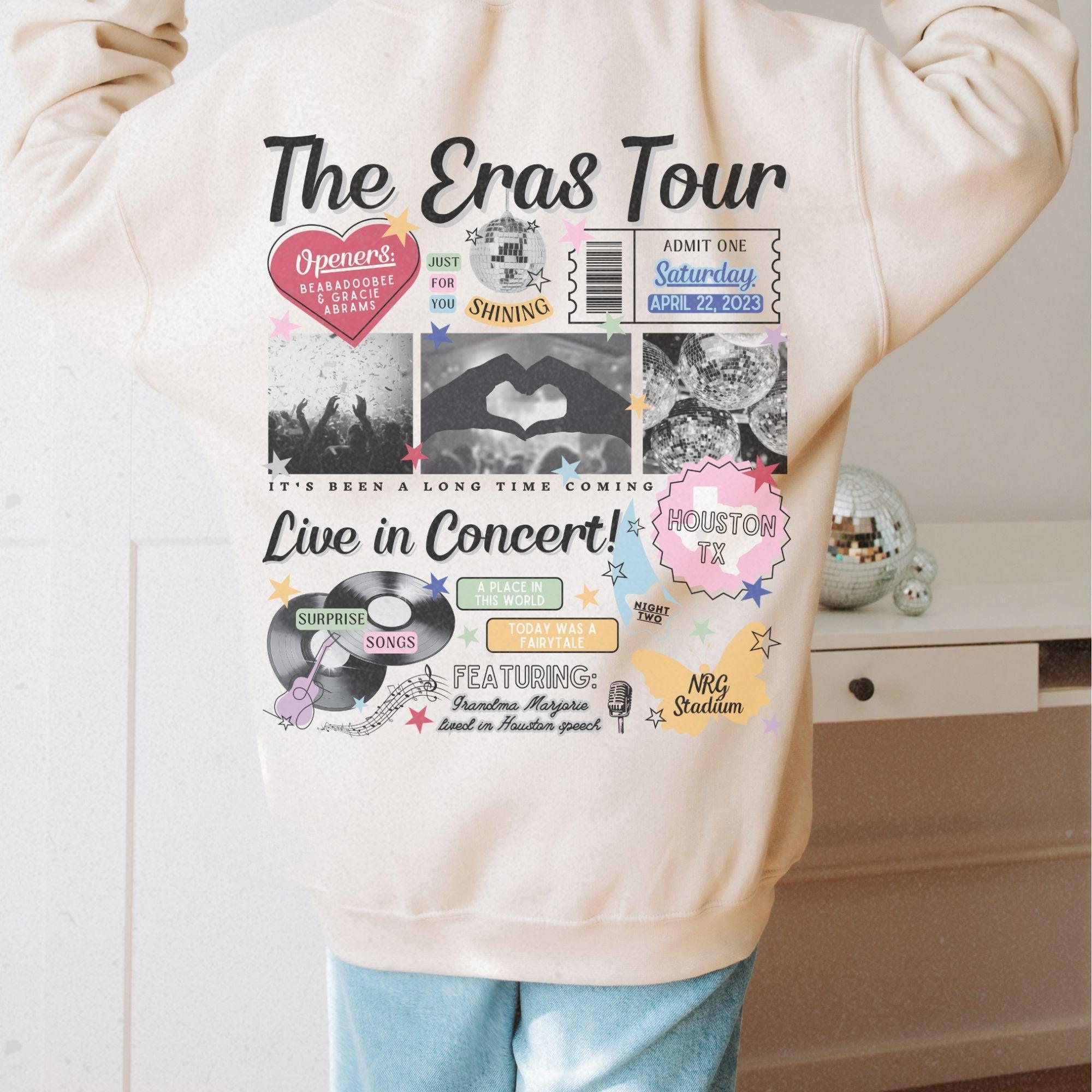 a person wearing a sweatshirt with the words the eras tour on it