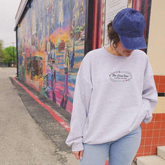 a woman standing on the side of a building