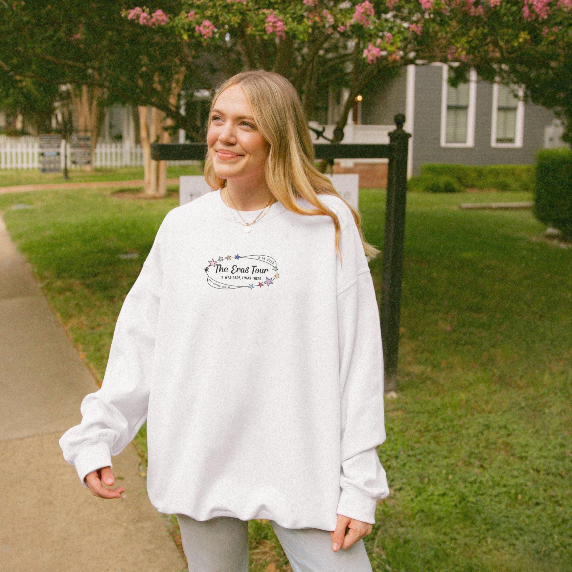 a woman standing on a sidewalk in front of a house